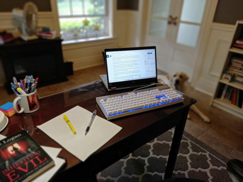 A personal office desk with a computer monitor screen that lists a guide to the tell-tale signs of a strong muse